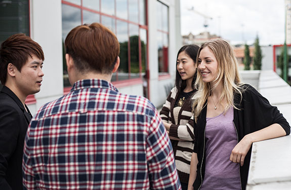 Students Talking Outside The Campus of Alexander College
