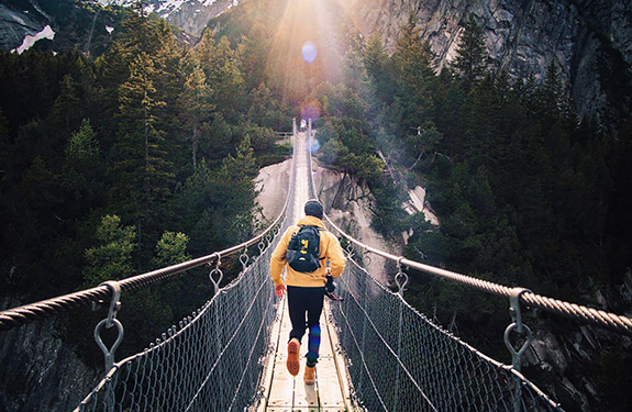 Guy running along the bridge
