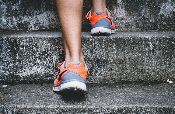 Female student walking up stairs for exercise