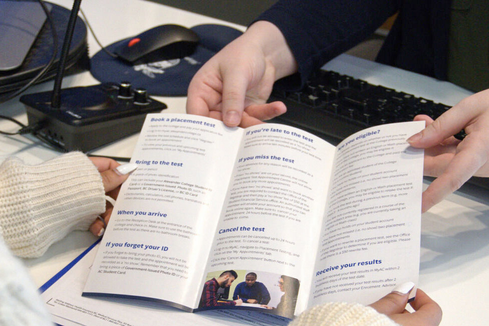 staff showing a student a brochure