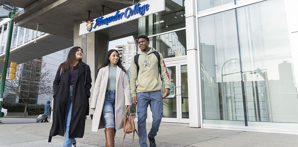 three students walking outside Alexander College Burnaby
