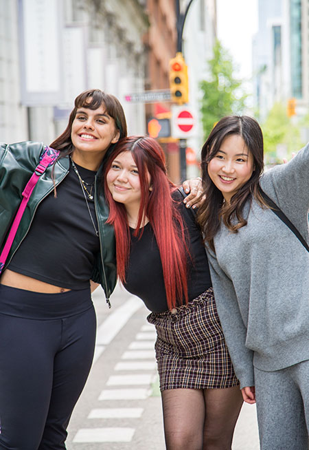 three students posing in downtown Vancouver