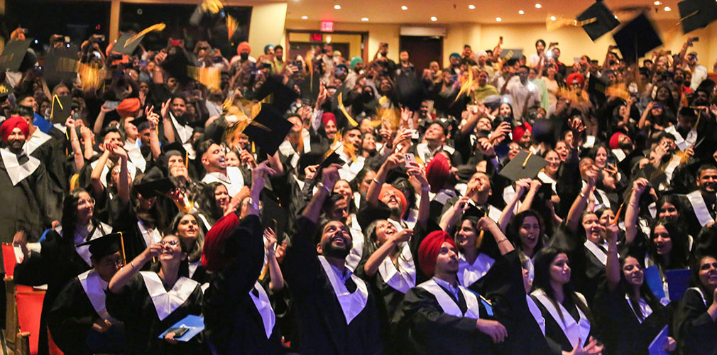 students throwing up their hats