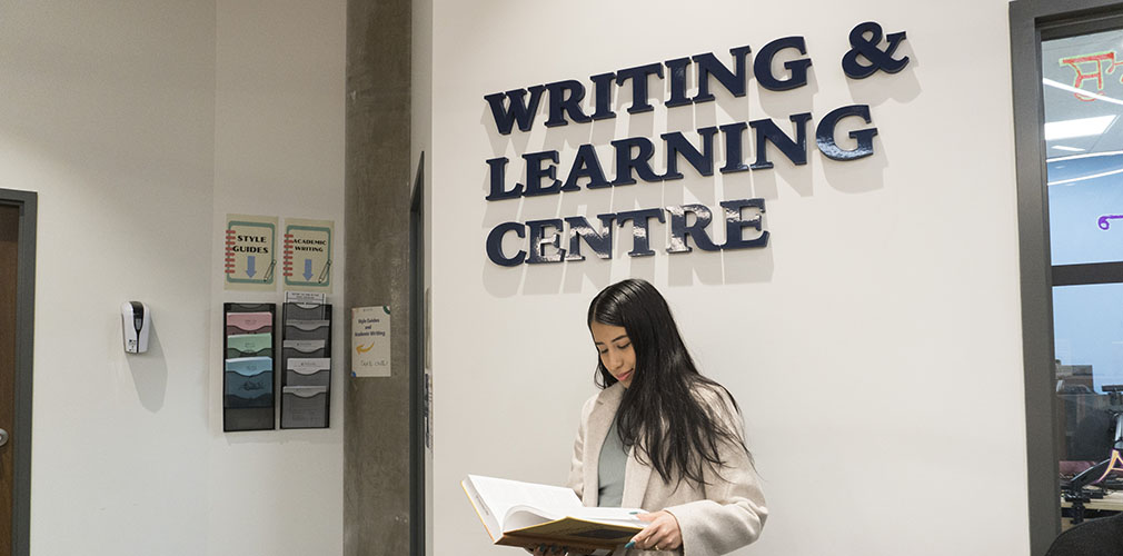 student reading in front of the WLC