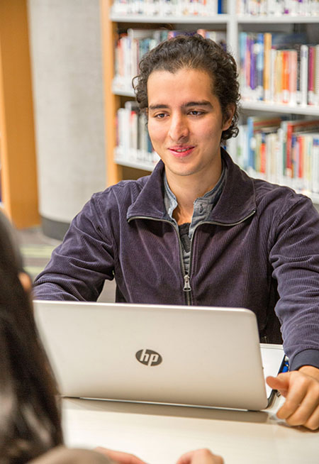 student looking at his laptop