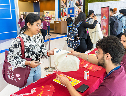 welcoming a student during New Student Orientation