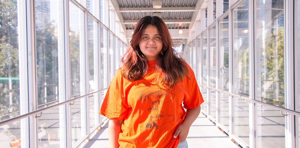 student wearing an orange shirt