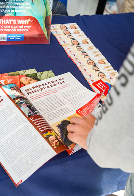 student flipping through volunteer pamphlet