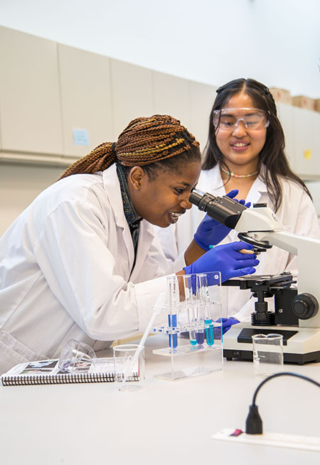 student using a microscope