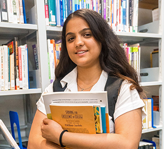 student holding a book