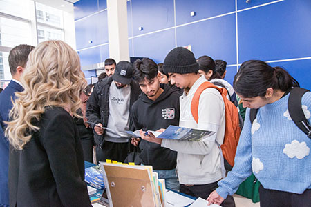 students reading university pamphlets