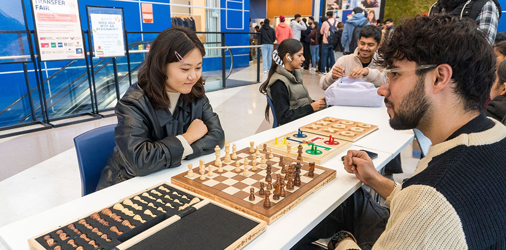 Enkhjin playing chess with another student