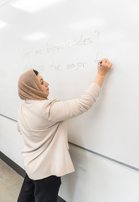 Mitra writing on the board