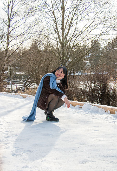 Annika crouching in the snow