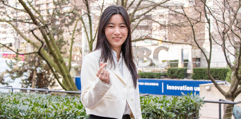 Louisa posing with a heart hand pose