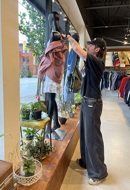 Hamish holding up a garment
