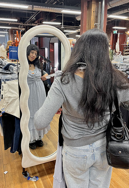 trying on a dress in front of the mirror