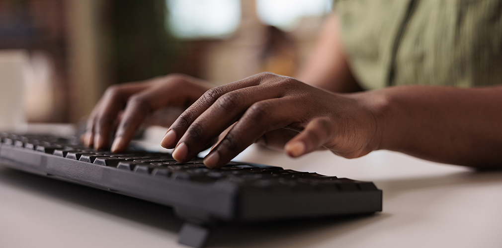 person typing on a keyboard