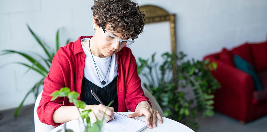 person writing in notebook