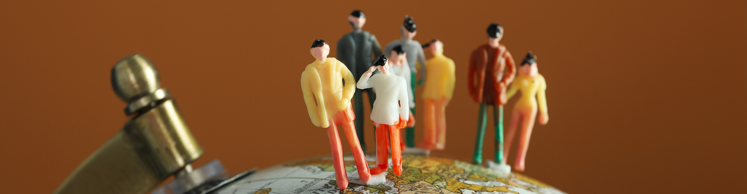 A group of people standing on a globe