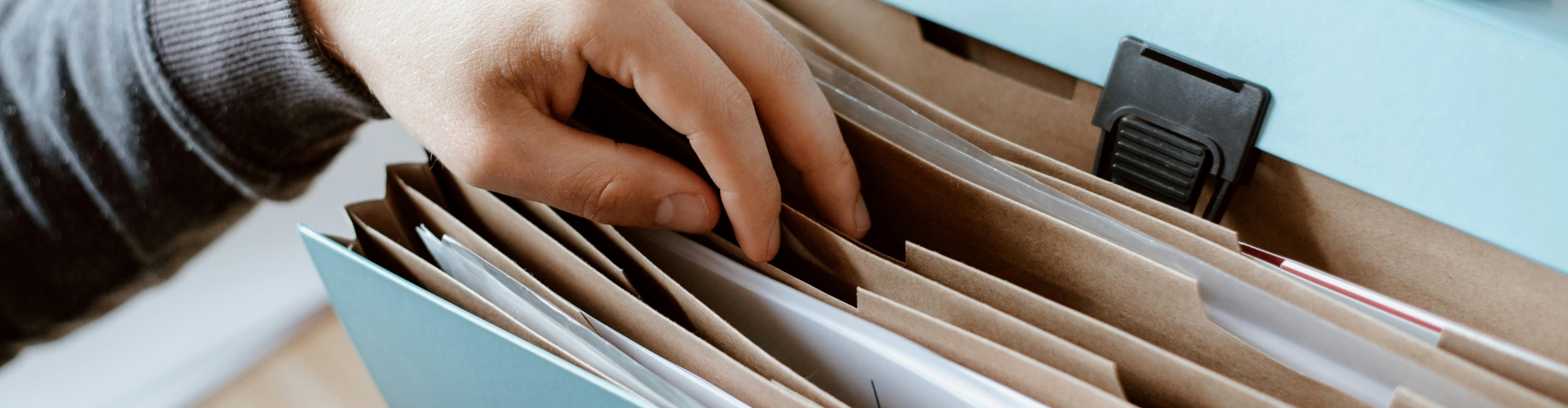 close up shot of staff going through a filing cabinet